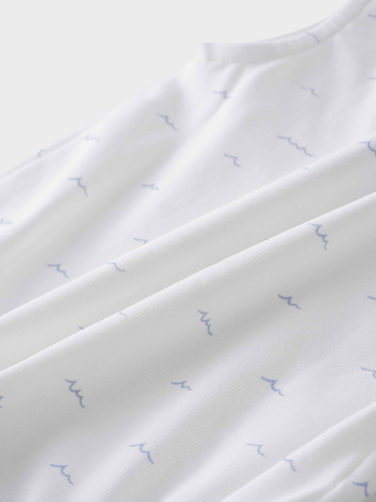 Beach-themed baby romper fabric close-up