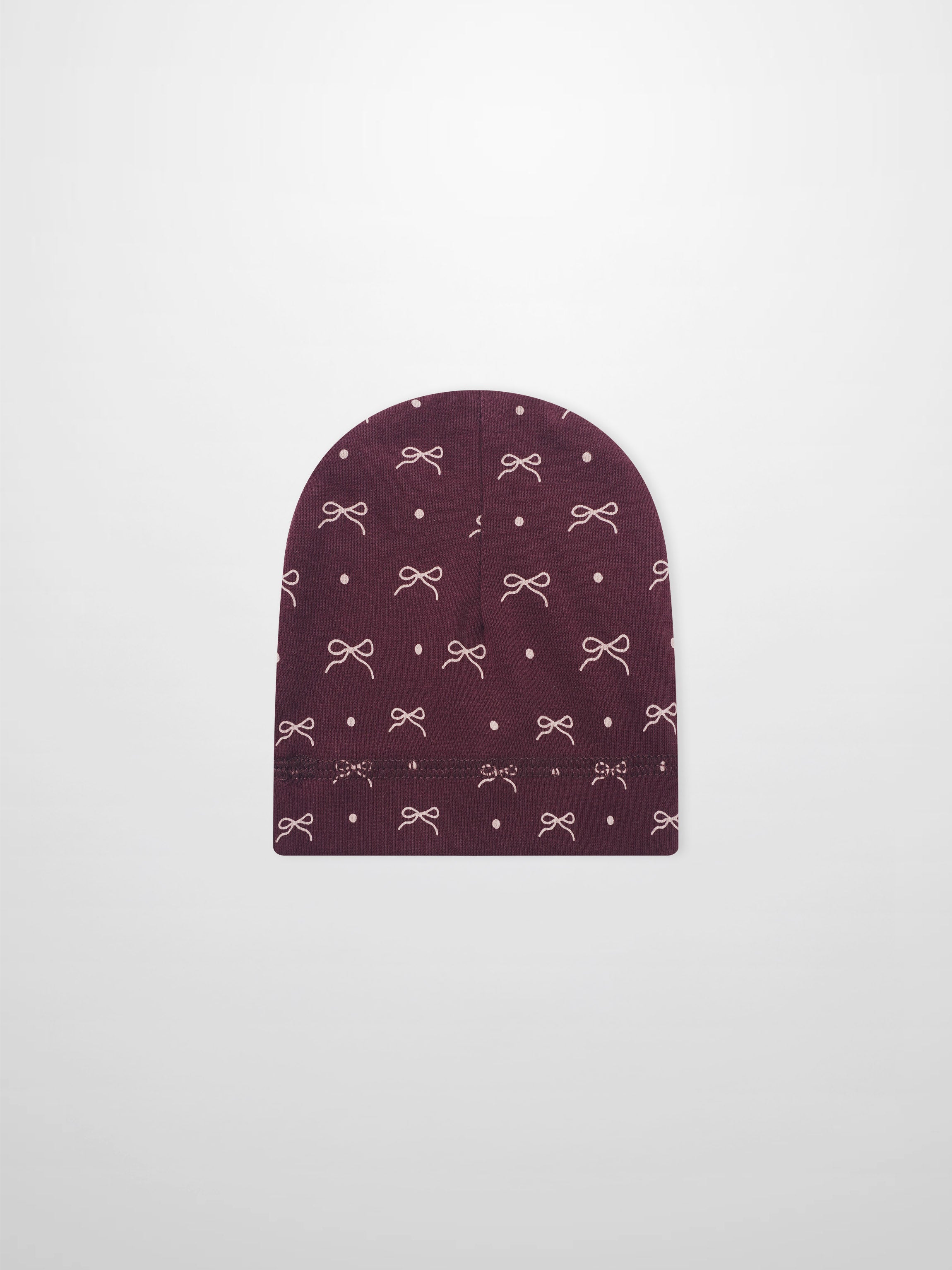 Girls burgundy bow hat with white bow and dot pattern on knit fabric