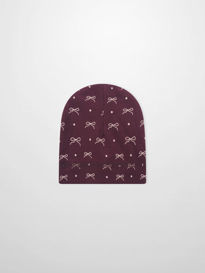 Girls burgundy bow hat with white bow and dot pattern on knit fabric