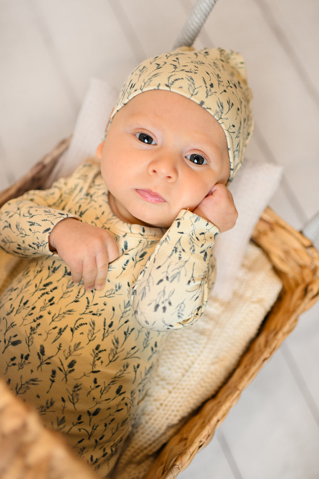 cute baby boy wearing soft jumpsuit with a beanie hat 