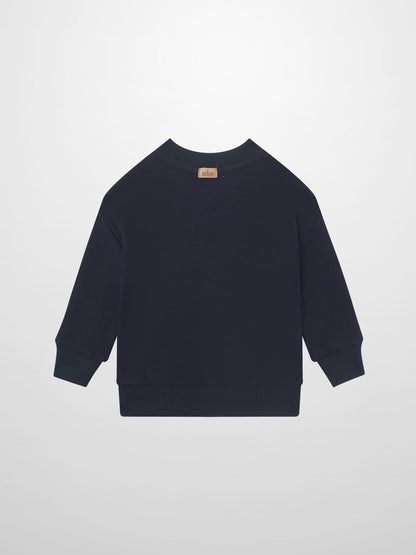 Merci Sweatshirt - Navy for boys by Adee; navy long-sleeve top with ribbed cuffs and tan back-neck tag.
