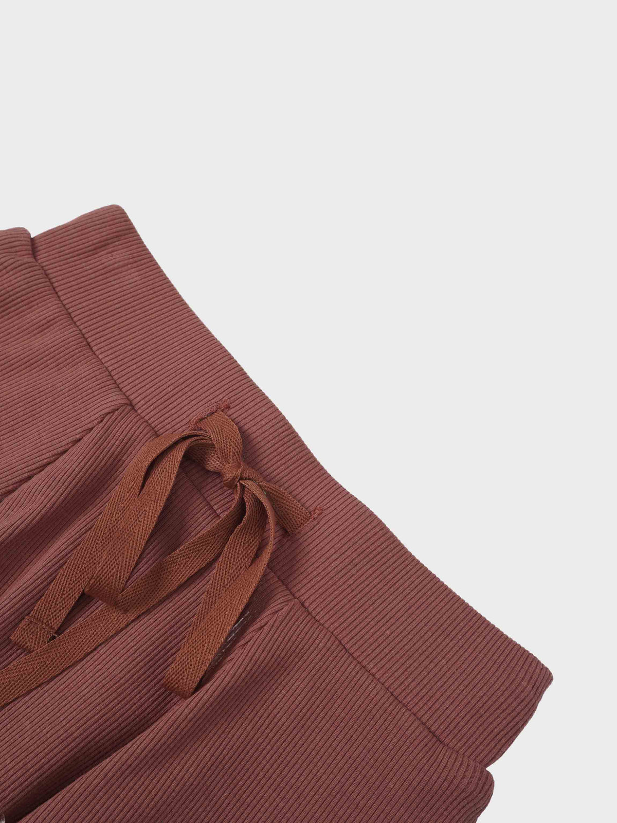 Brick-colored ribbed knit Embossed Logo Skirt with a tied drawstring waist.