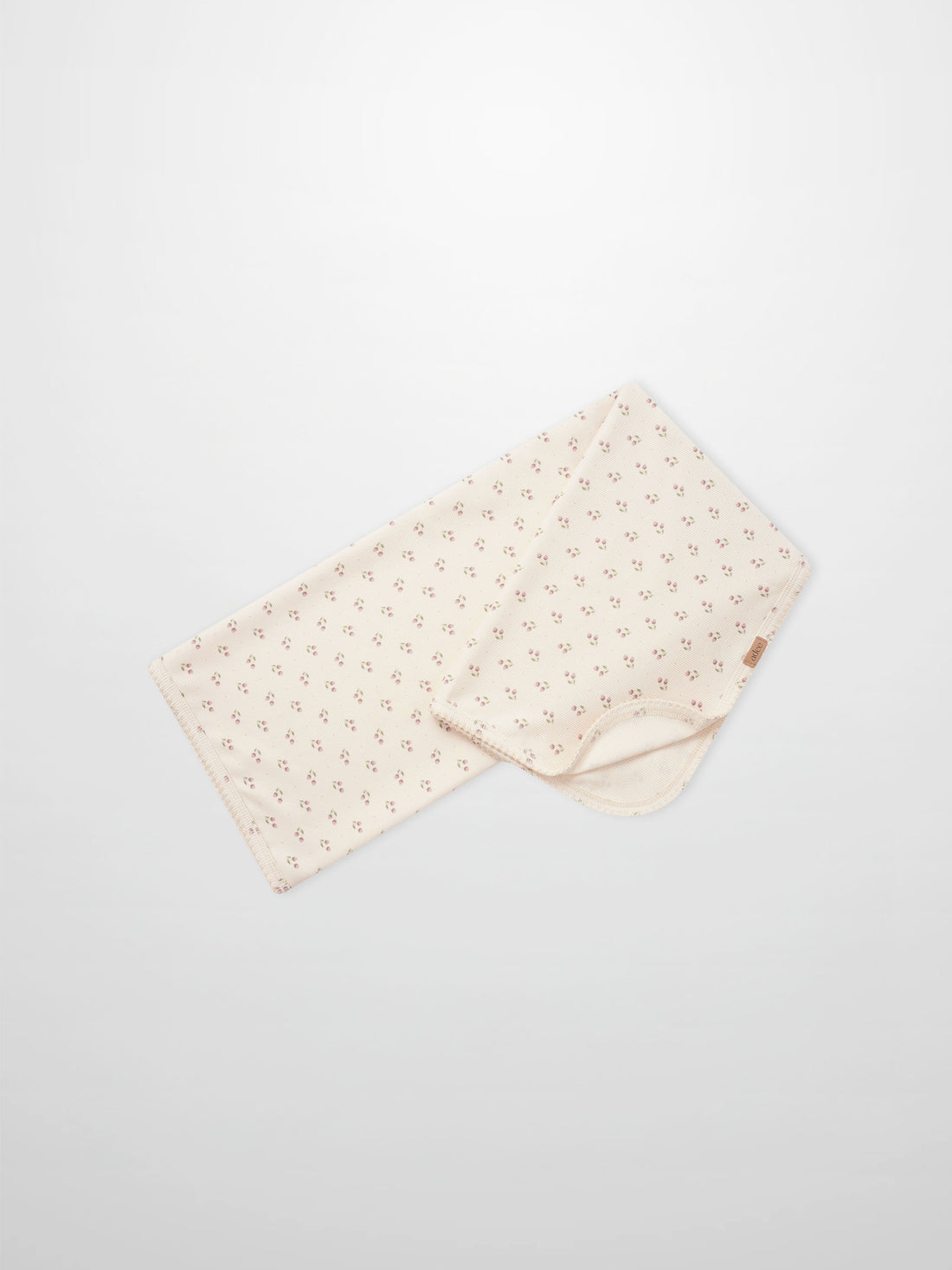 Tiny Tulip Blanket by Adee; cream girls swaddle blanket with tiny pink tulip floral pattern.