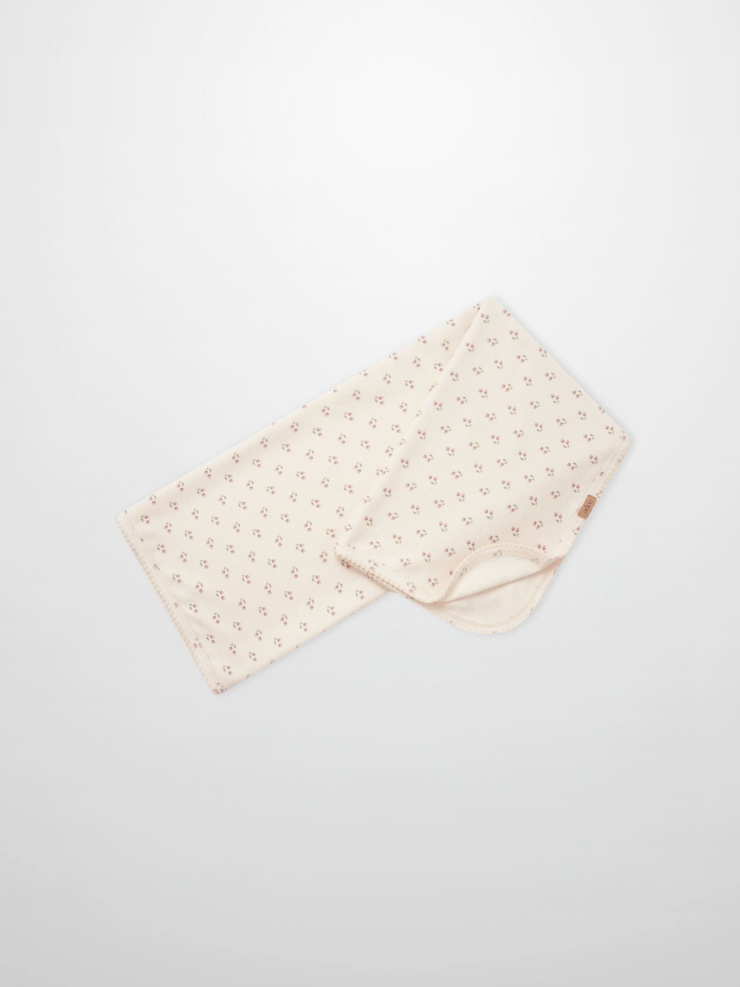 Tiny Tulip Blanket by Adee; cream girls swaddle blanket with tiny pink tulip floral pattern.