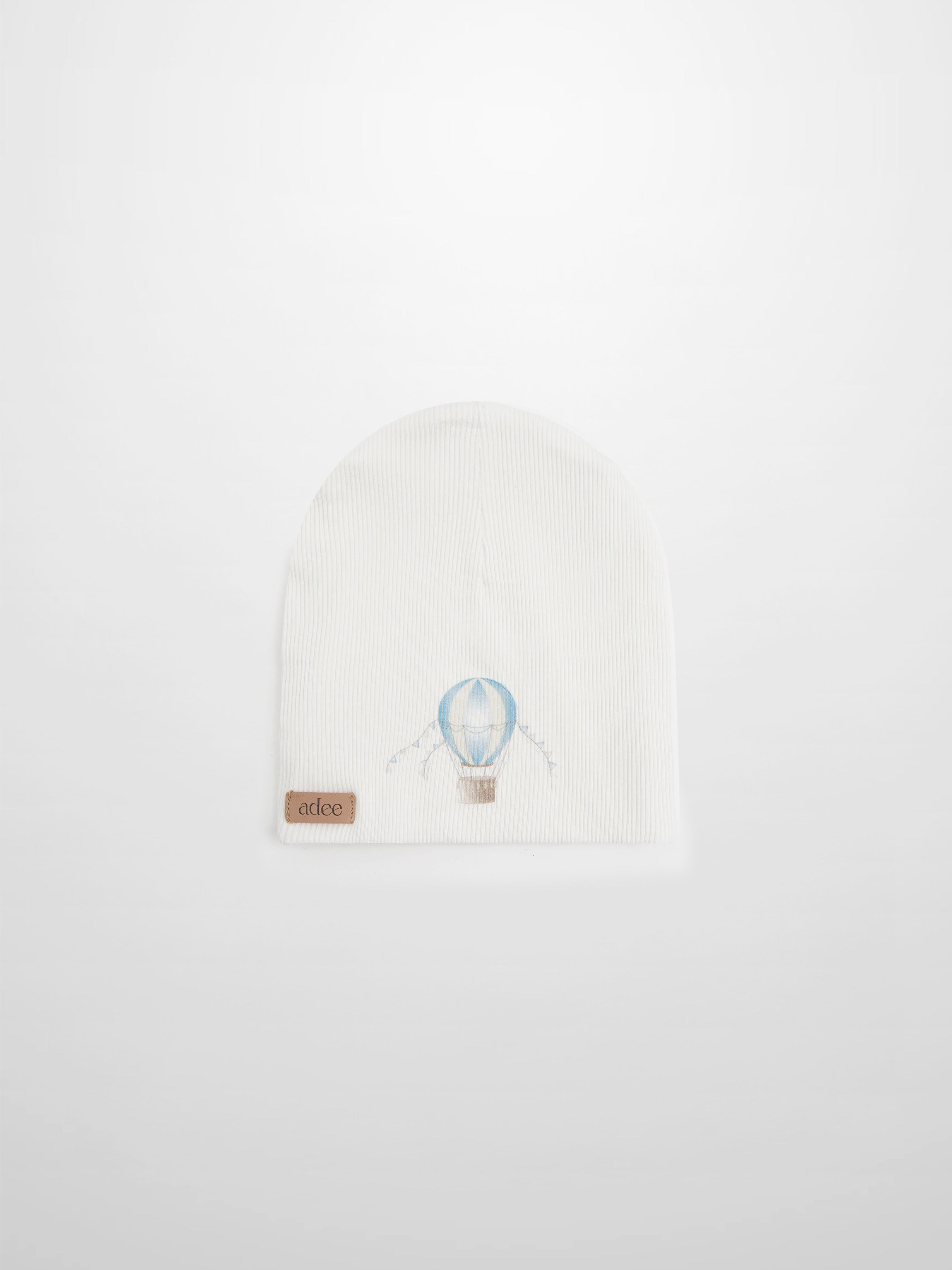 Blue Balloon Beanie for boys by Adee, white knit with light blue balloon motif and tan leather tag.