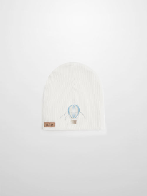 Blue Balloon Beanie for boys by Adee, white knit with light blue balloon motif and tan leather tag.