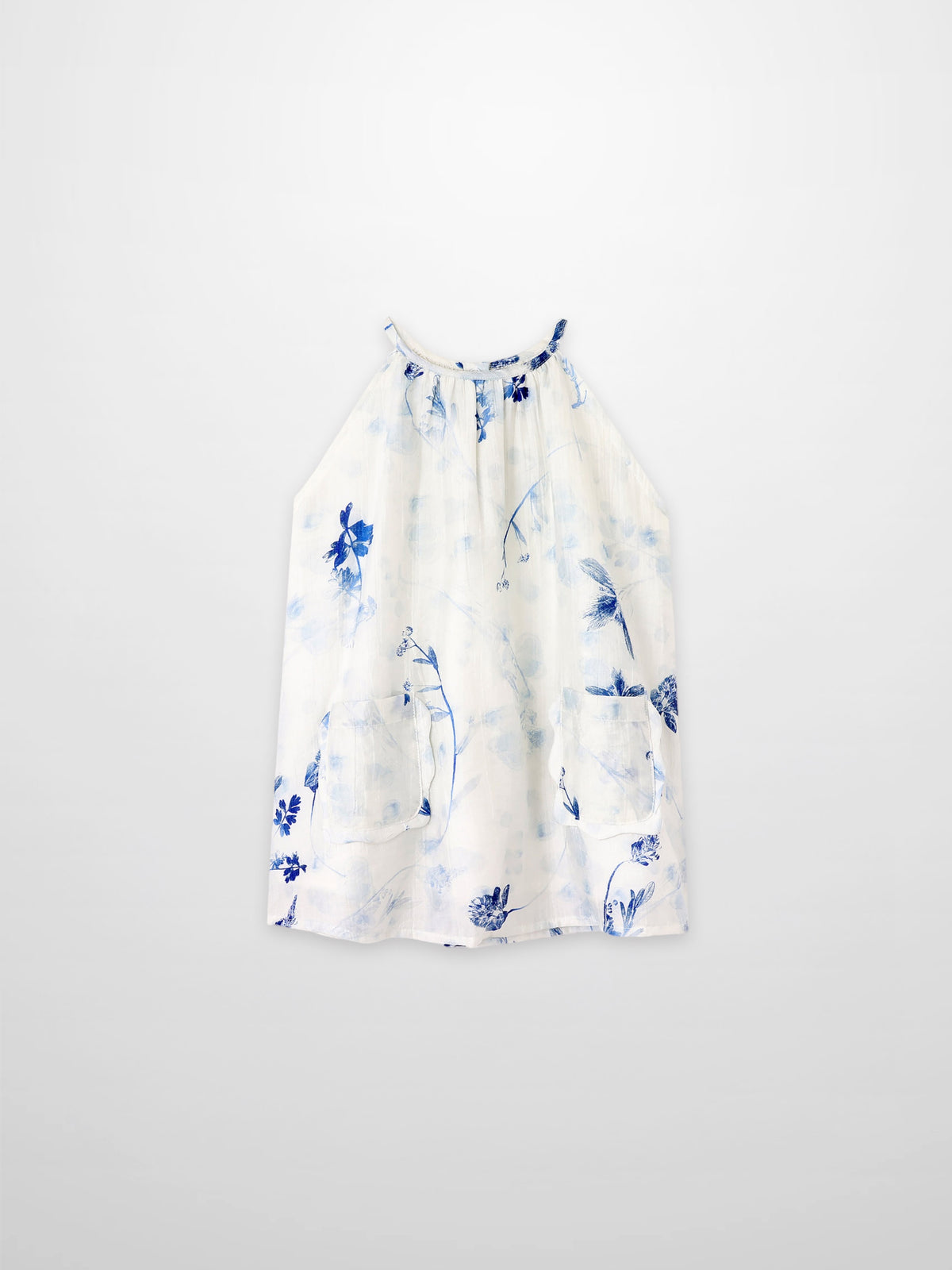 Blue Flower Jumper dress by Adee; white fabric with blue floral print and front pockets.
