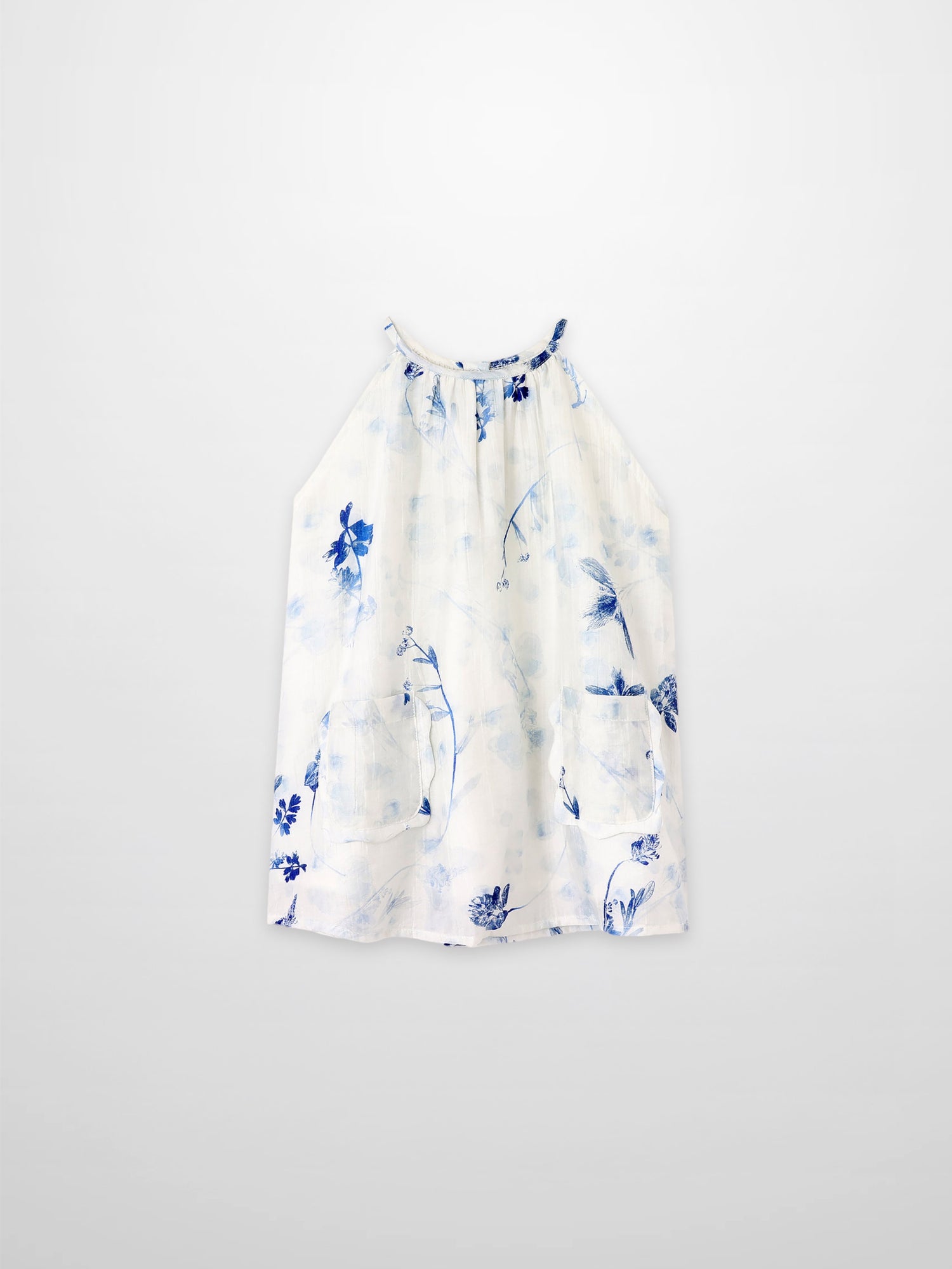 Blue Flower Jumper dress by Adee; white fabric with blue floral print and front pockets.