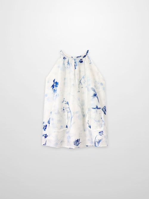 Blue Flower Jumper dress by Adee; white fabric with blue floral print and front pockets.