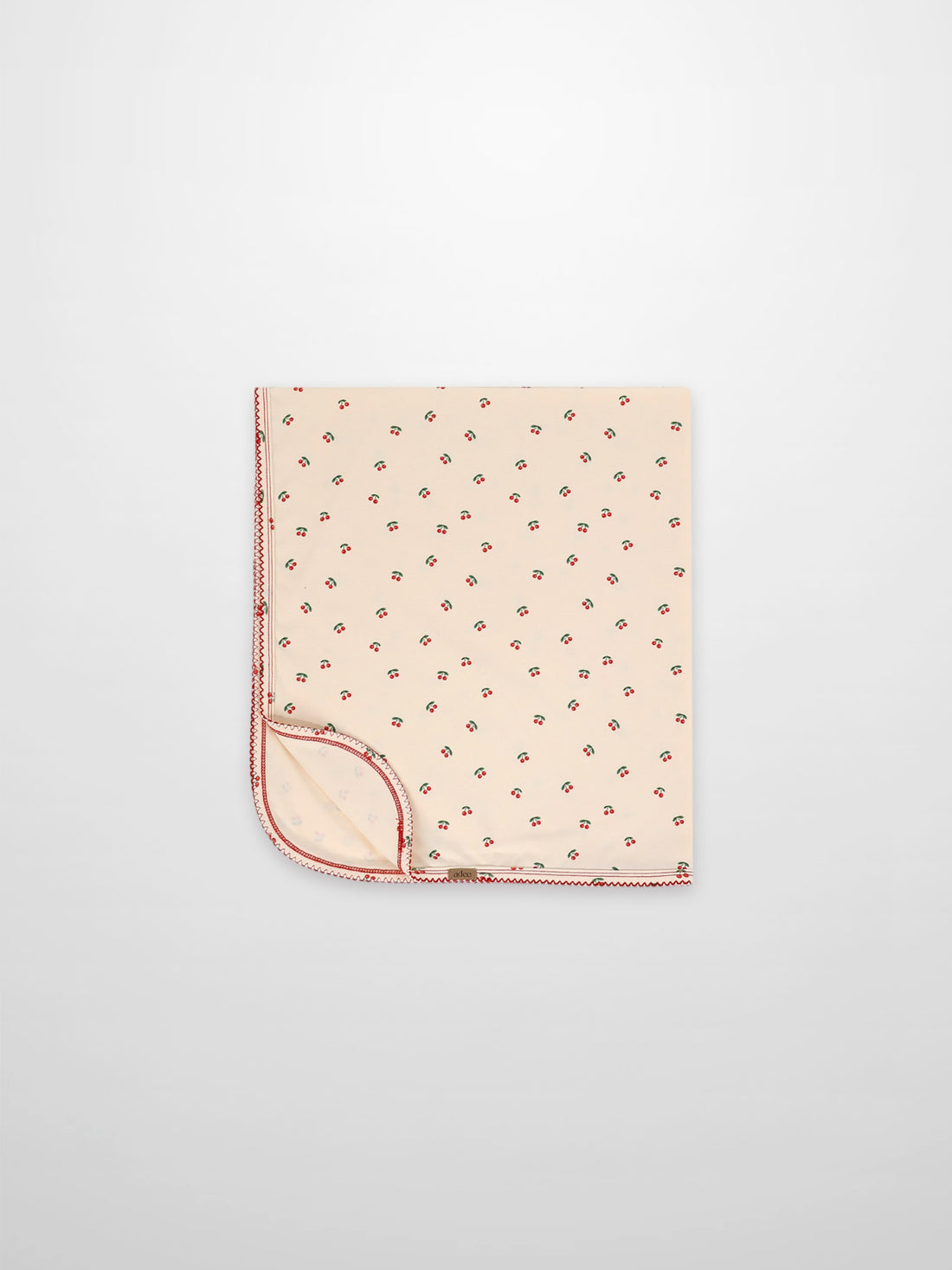Adee red cherry receiving blanket with cream background and red lace trim