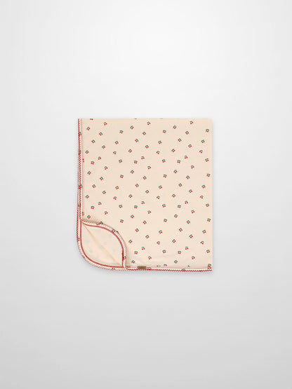 Adee red cherry receiving blanket with cream background and red lace trim