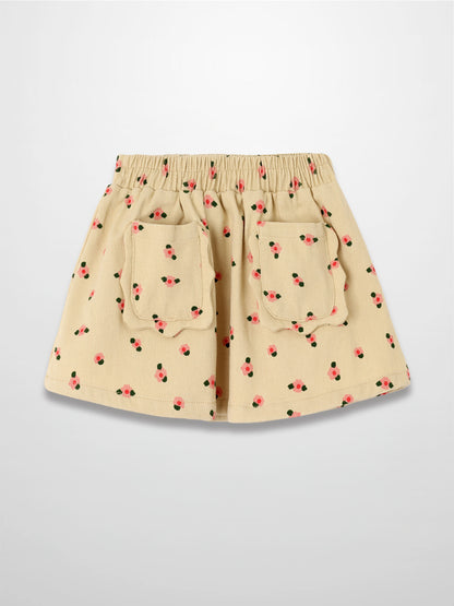 Tan floral skirt with pink blossoms and green leaves, elastic waist and two back pockets.