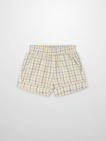 Plaid Shorts in pale yellow with blue checks, elastic waistband and side pockets.