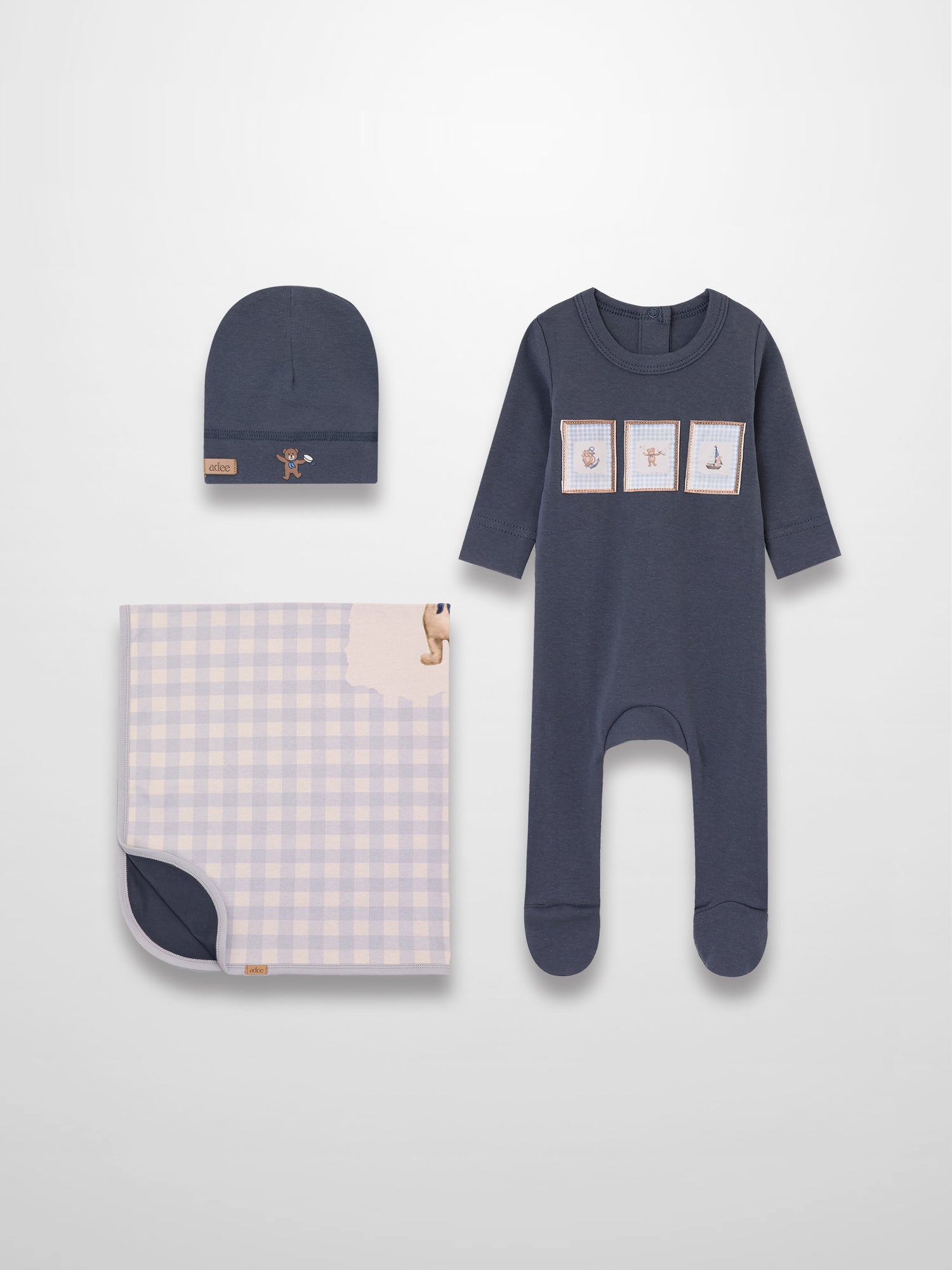 Teddy Frame Layette Set 3-piece baby boys by Adee: navy romper with patches, navy beanie, lavender gingham blanket.