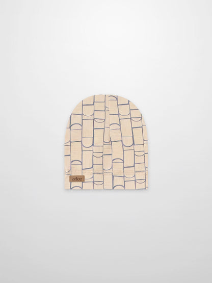 Geometric hat for boys in light blue on beige fabric with Adee brand patch