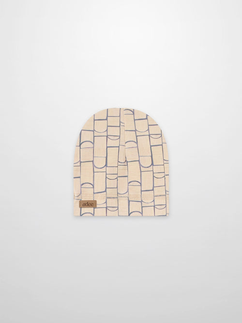 Geometric hat for boys in light blue on beige fabric with Adee brand patch