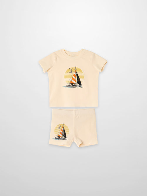 Golden Sail Shorts Set, peach two-piece outfit for little boys with a sailboat graphic.