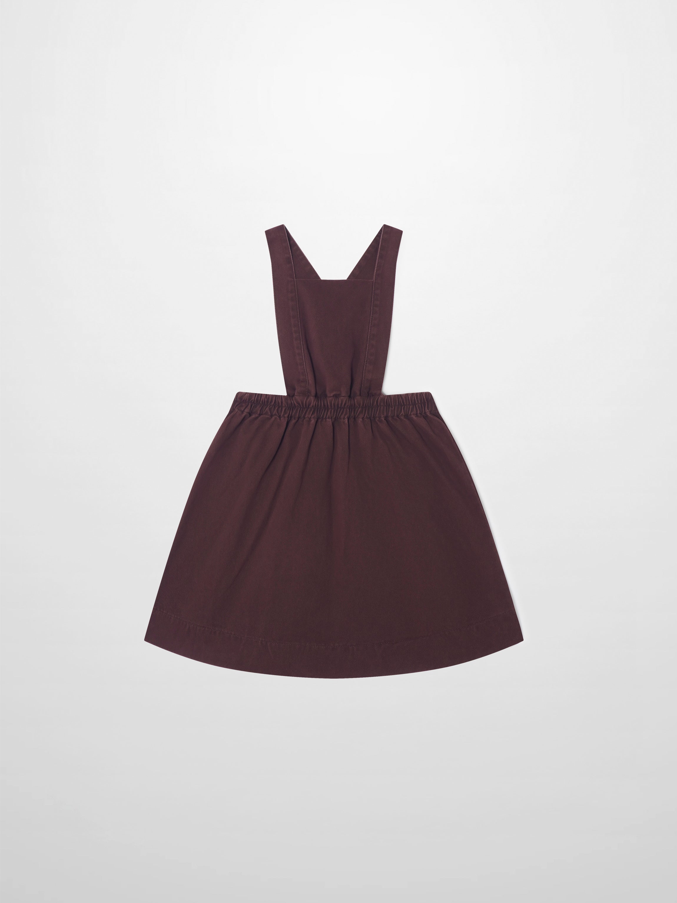 Denim jumper dress for girls in burgundy with wide straps and elastic waist.