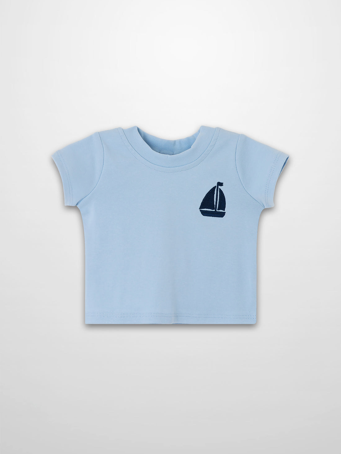 Light blue short-sleeve boxy T-shirt with navy sailboat emblem on chest.