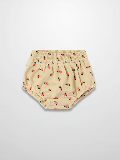 Tan floral bloomers with pink flowers and green leaves, elastic waist and gathered leg openings.