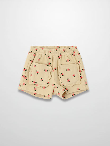 Tan Floral Shorts with pink flowers and green leaves, elastic waistband, and large back pockets.