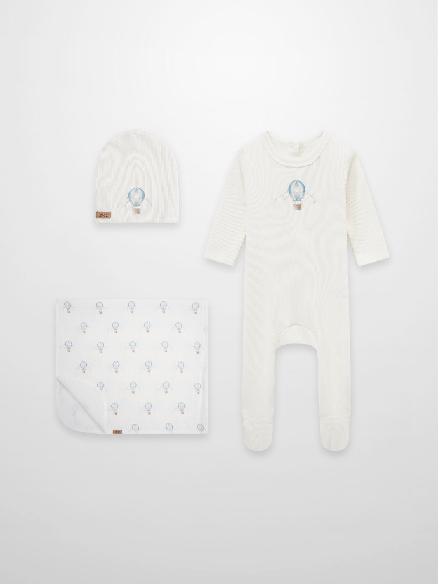 Adee Blue Balloon layette set: cream romper with blue balloon motif, matching hat and patterned blanket