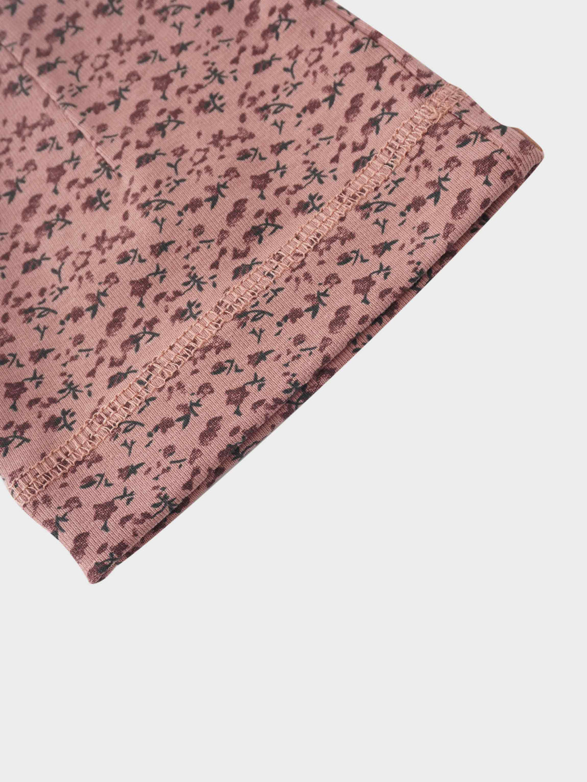 baby girls beanie hat with printed roses in a light pink background