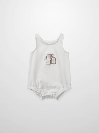 Adee Mini Gallery Romper for baby girls, white sleeveless romper with small framed print on front; snap bottom.
