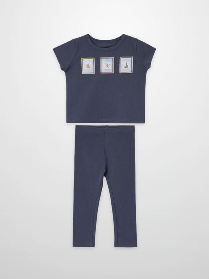 Teddy Frame Set by Adee; navy blue 2-piece little boys outfit with top featuring three framed prints and matching pants.