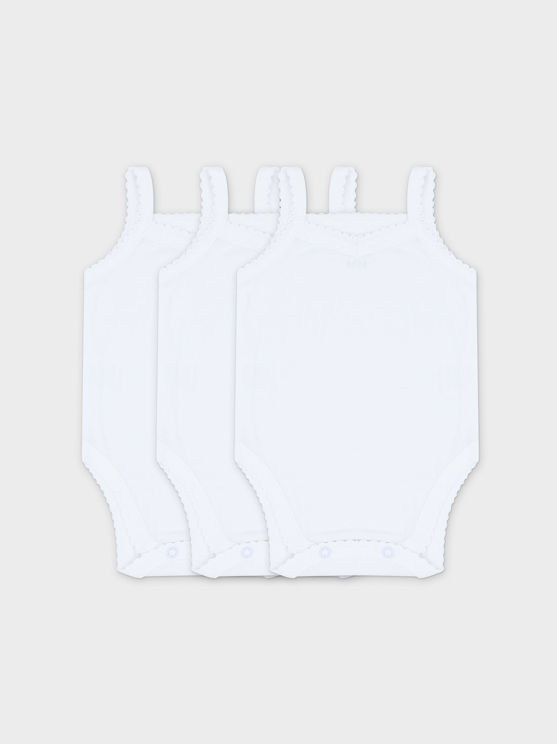 Set of three white baby bodysuits