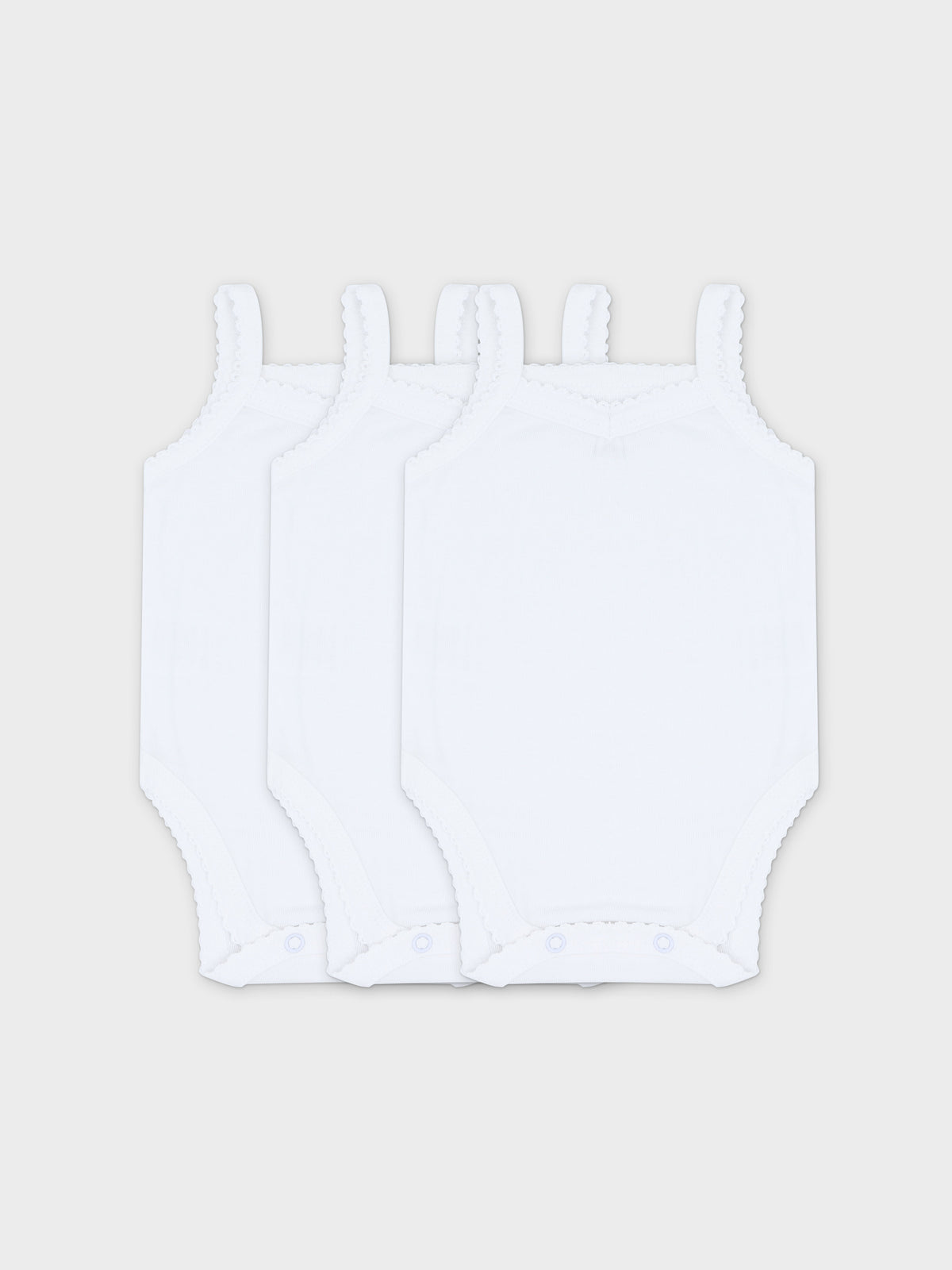 Set of three white baby bodysuits