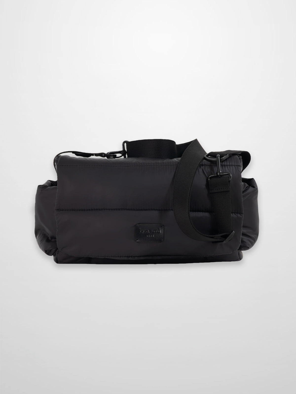 Diaper bag in sleek black padded fabric with a foldover design and adjustable strap for style and practicality.