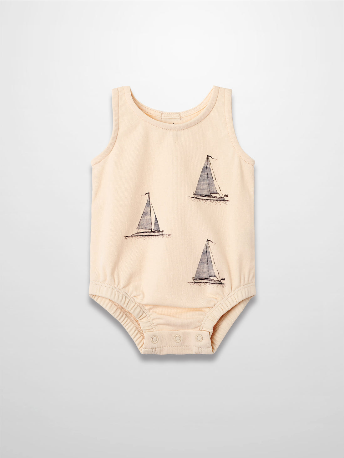 Peach-colored baby romper with three navy sailboat prints and snap closures.