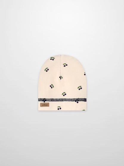 Blue cherry hat for boys by Adee, beige fabric with green leaves