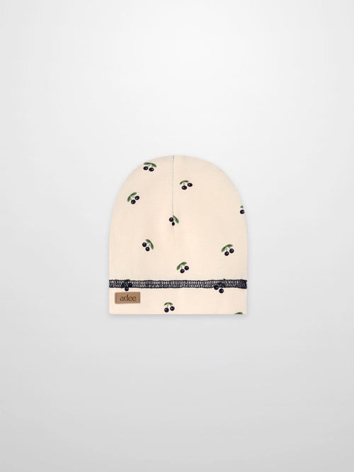 Blue cherry hat for boys by Adee, beige fabric with green leaves