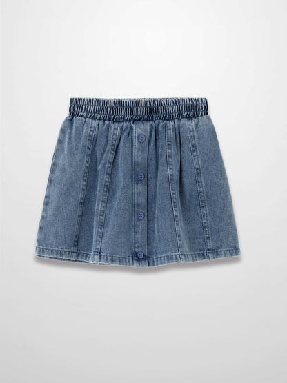 Paneled blue denim skirt with elastic waistband and front blue button placket.