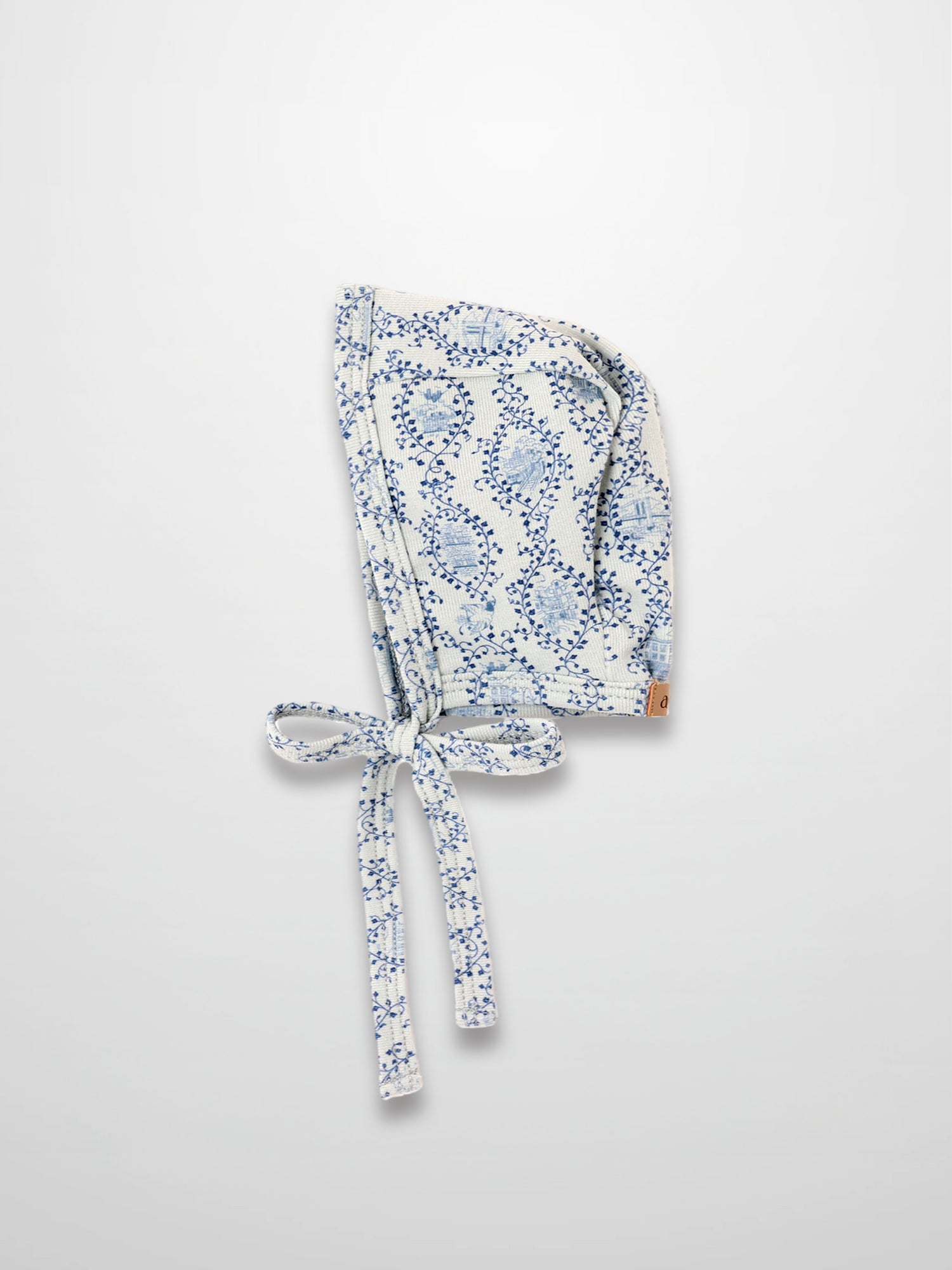 Blue Charm Bonnet for boys with dark blue vine pattern and tied straps by Adee.
