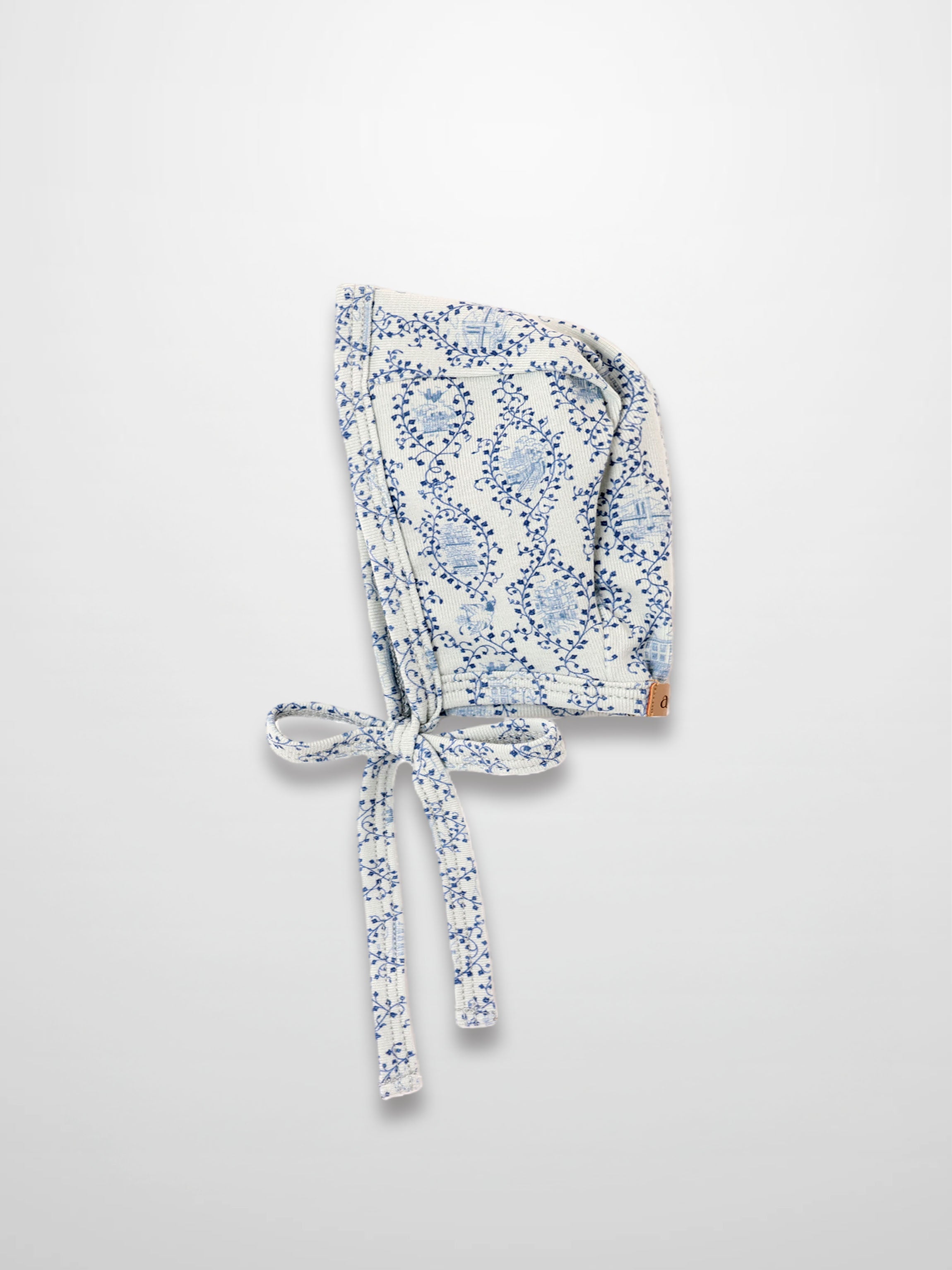 Blue Charm Bonnet for boys with dark blue vine pattern and tied straps by Adee.