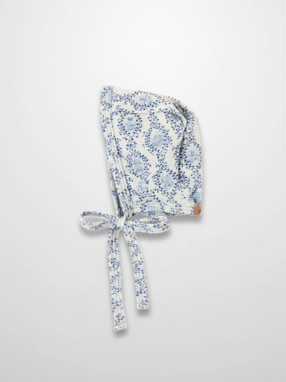 Blue Charm Bonnet for boys with dark blue vine pattern and tied straps by Adee.