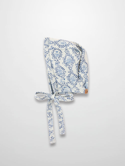Blue Charm Bonnet for boys with dark blue vine pattern and tied straps by Adee.