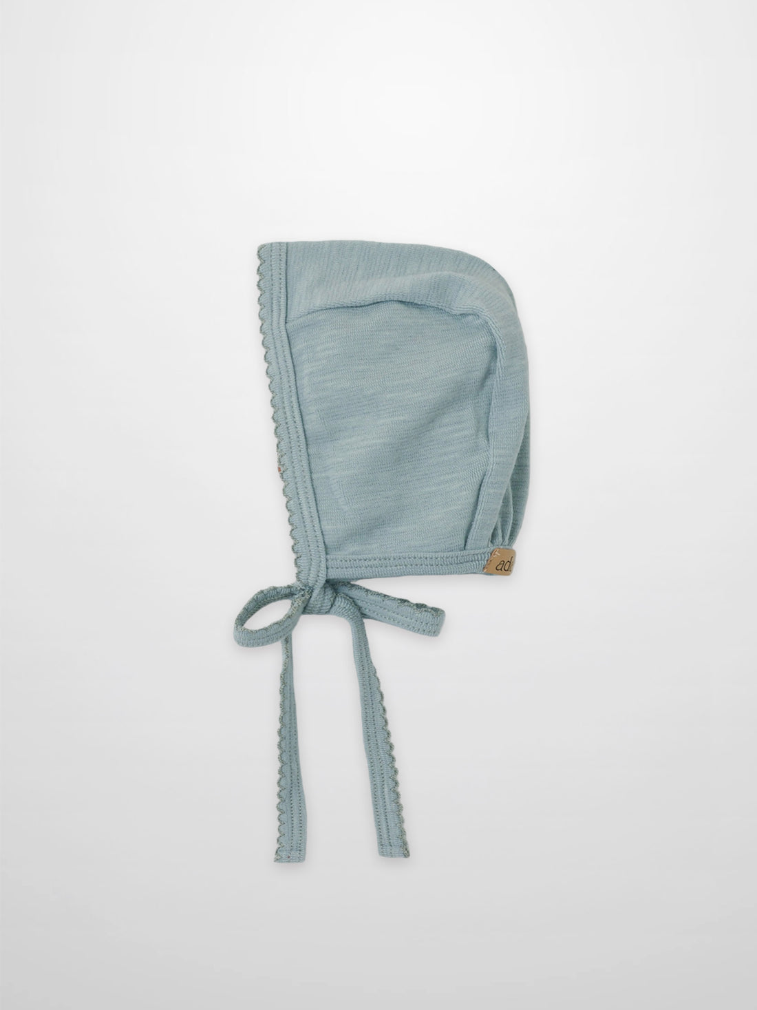 Blue scalloped bonnet for boys by Adee; soft light-blue fabric with scalloped trim and ties
