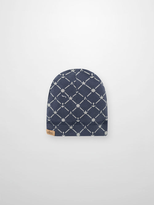 Crossover Anchor Beanie - Navy with white rope diamond pattern, anchors, stars, ship wheels, and the letter A.