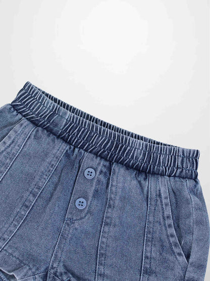 Paneled blue denim shorts with elastic waistband, front button placket, and side pockets.