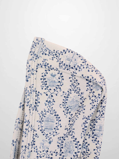 Blue Charm Bonnet for boys by Adee; beige knit fabric with dark blue vine pattern.