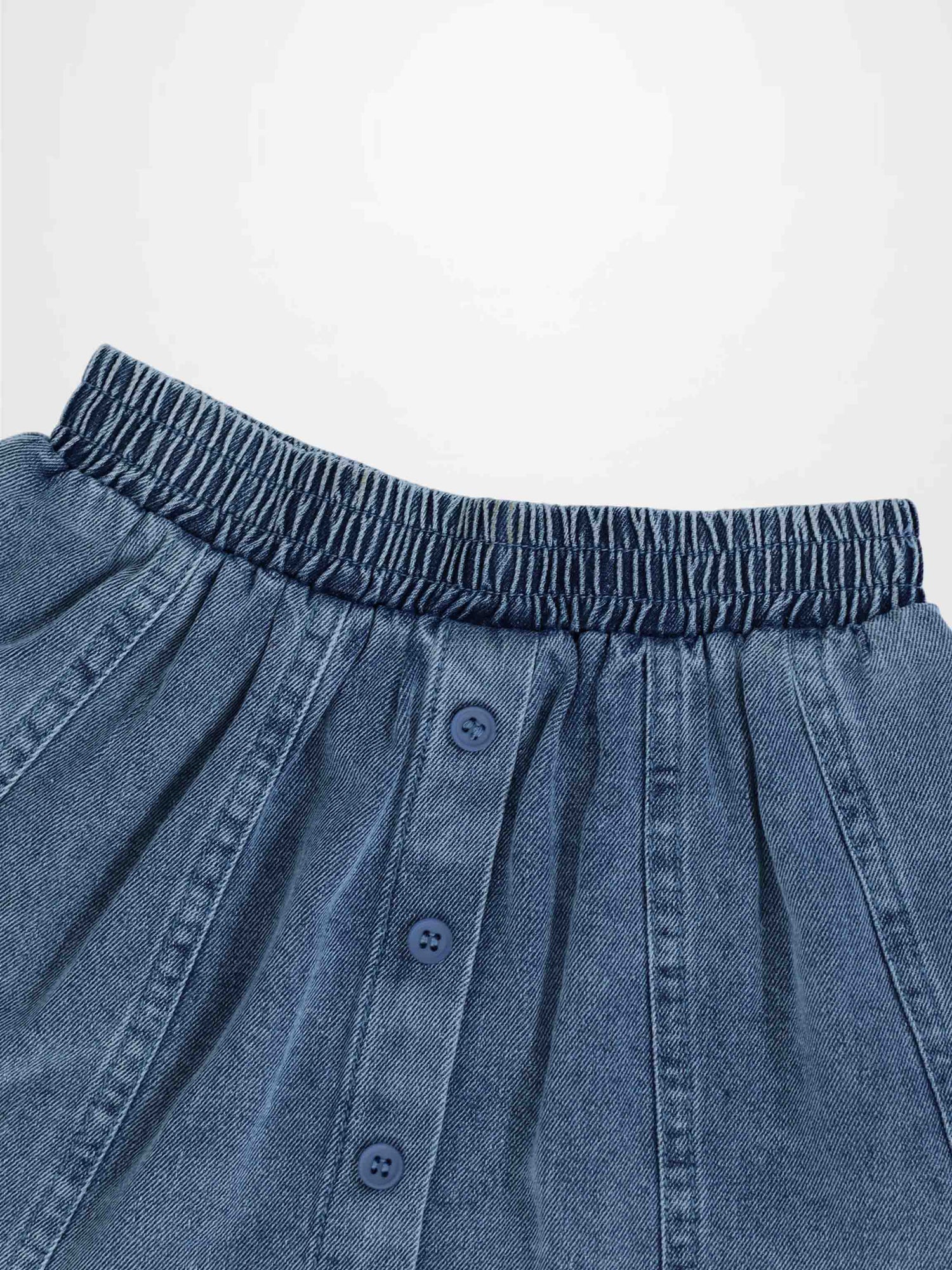 Blue denim paneled skirt with elastic waistband and button-front placket