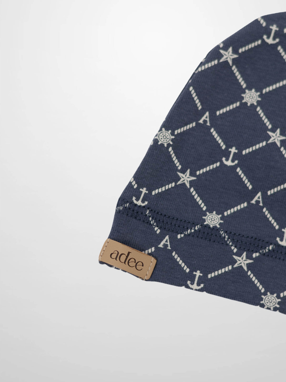 Crossover Anchor Beanie - Navy with white rope diamond pattern featuring anchors, stars, ship wheels, and Adee label.