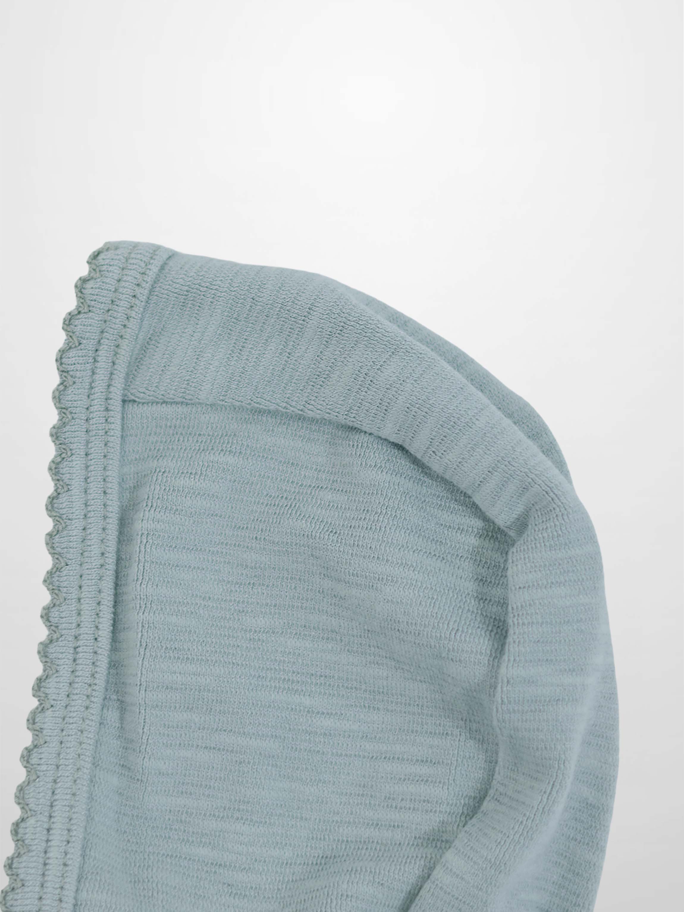 Blue scalloped bonnet for boys made from soft light-blue knit fabric, featuring a decorative scalloped edge.