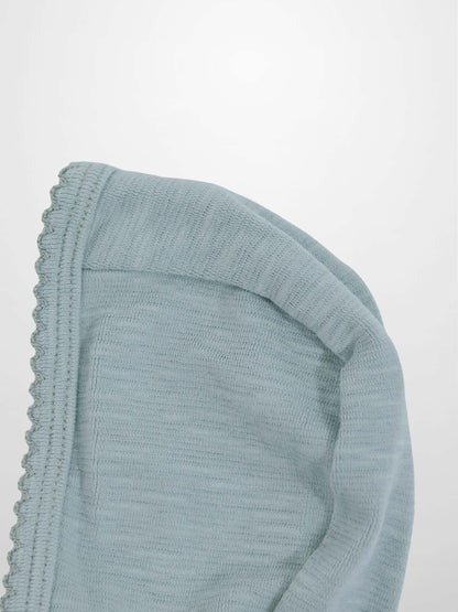 Blue scalloped bonnet for boys made from soft light-blue knit fabric, featuring a decorative scalloped edge.