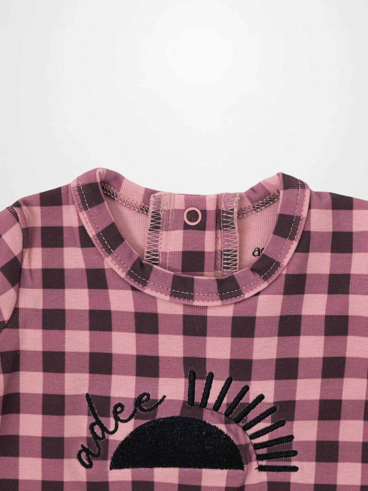 Pink gingham baby footie with sun embroidery and Adee on front; soft stretchy fabric, inseam zipper.