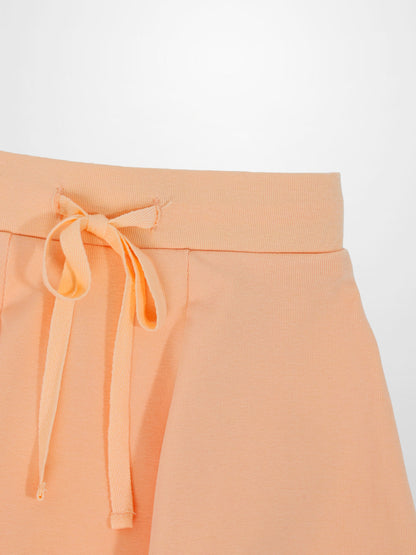Peach 6-panel skirt with drawstring waist.
